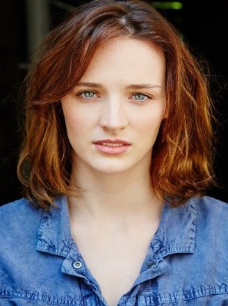 Airlie Dodds posing by wearing blue jeans shirt.